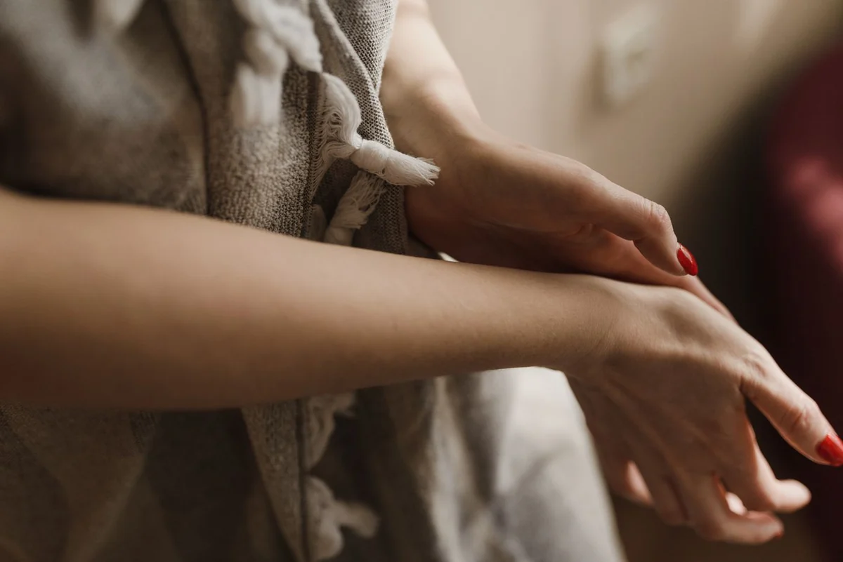 Red manicured nails and a soft robe, a quiet self-care moment