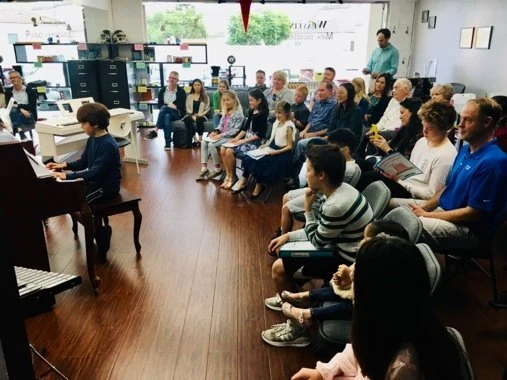 A piano performance with an audience.