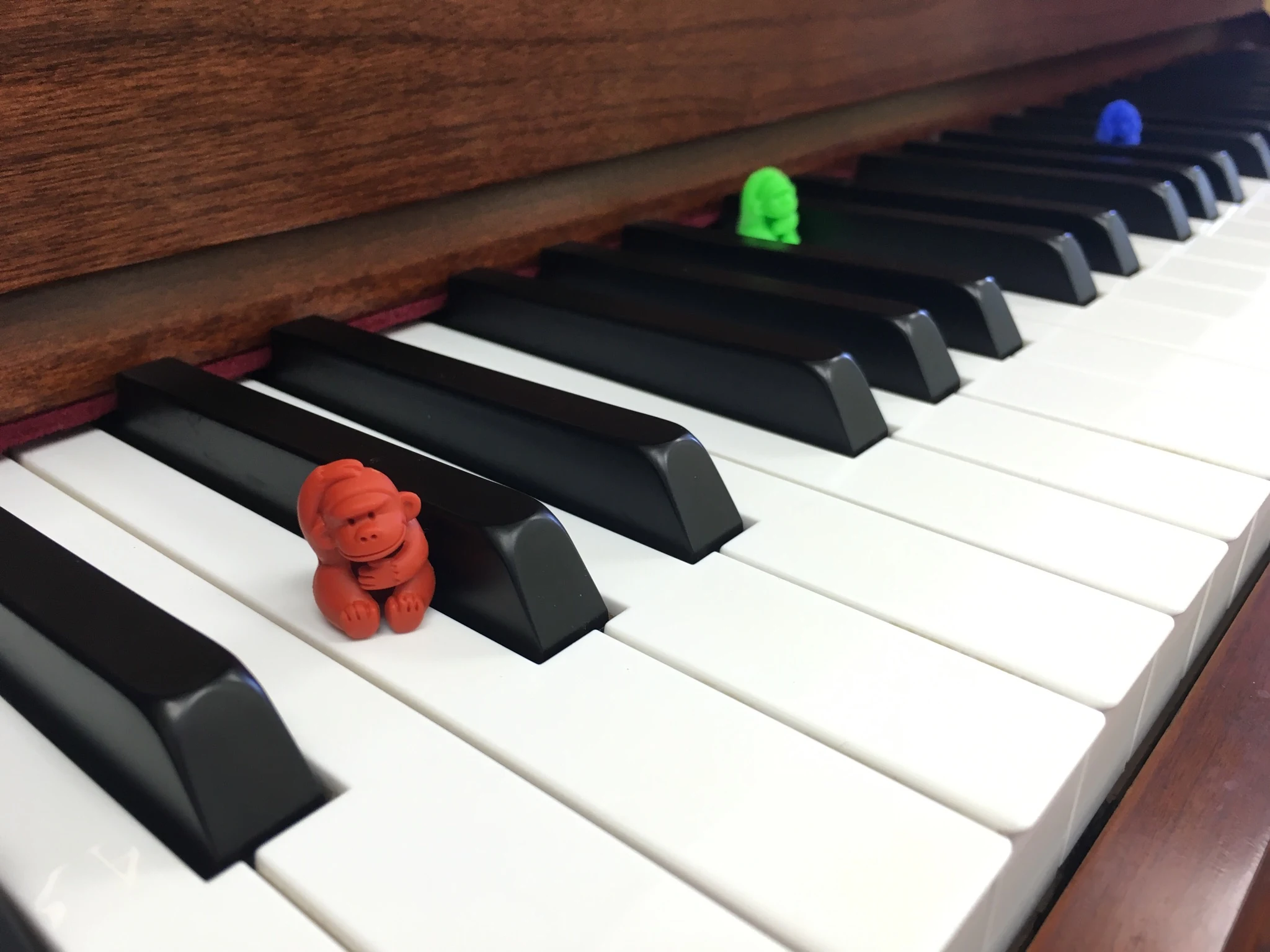 Handcrafted figures on a piano keyboard.