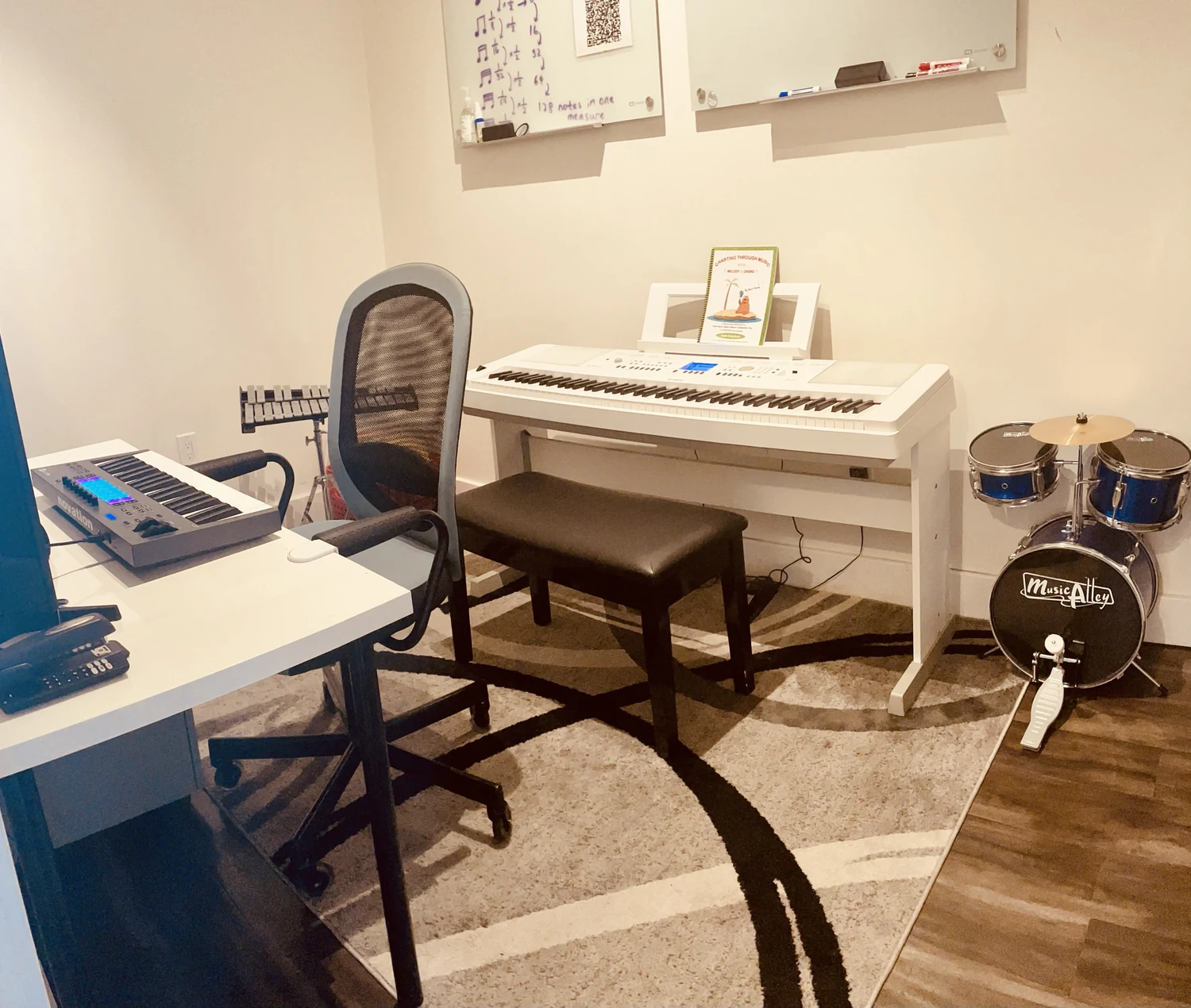A music room with piano and drums.