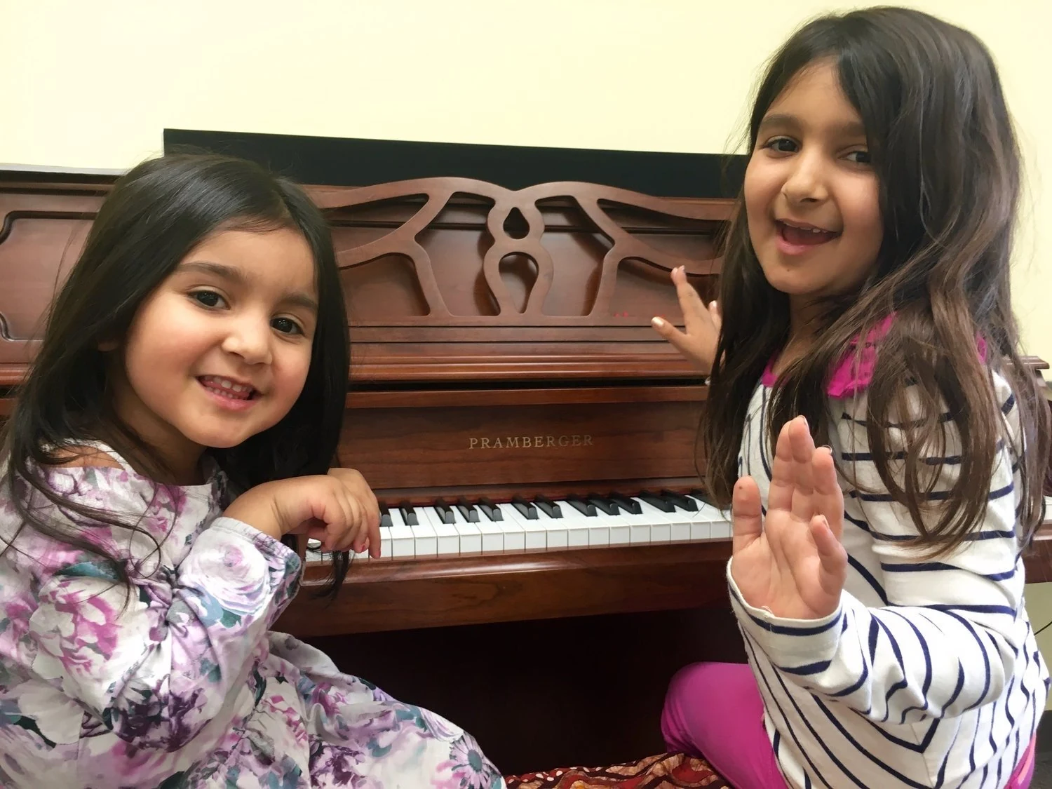 Two students beside a piano.