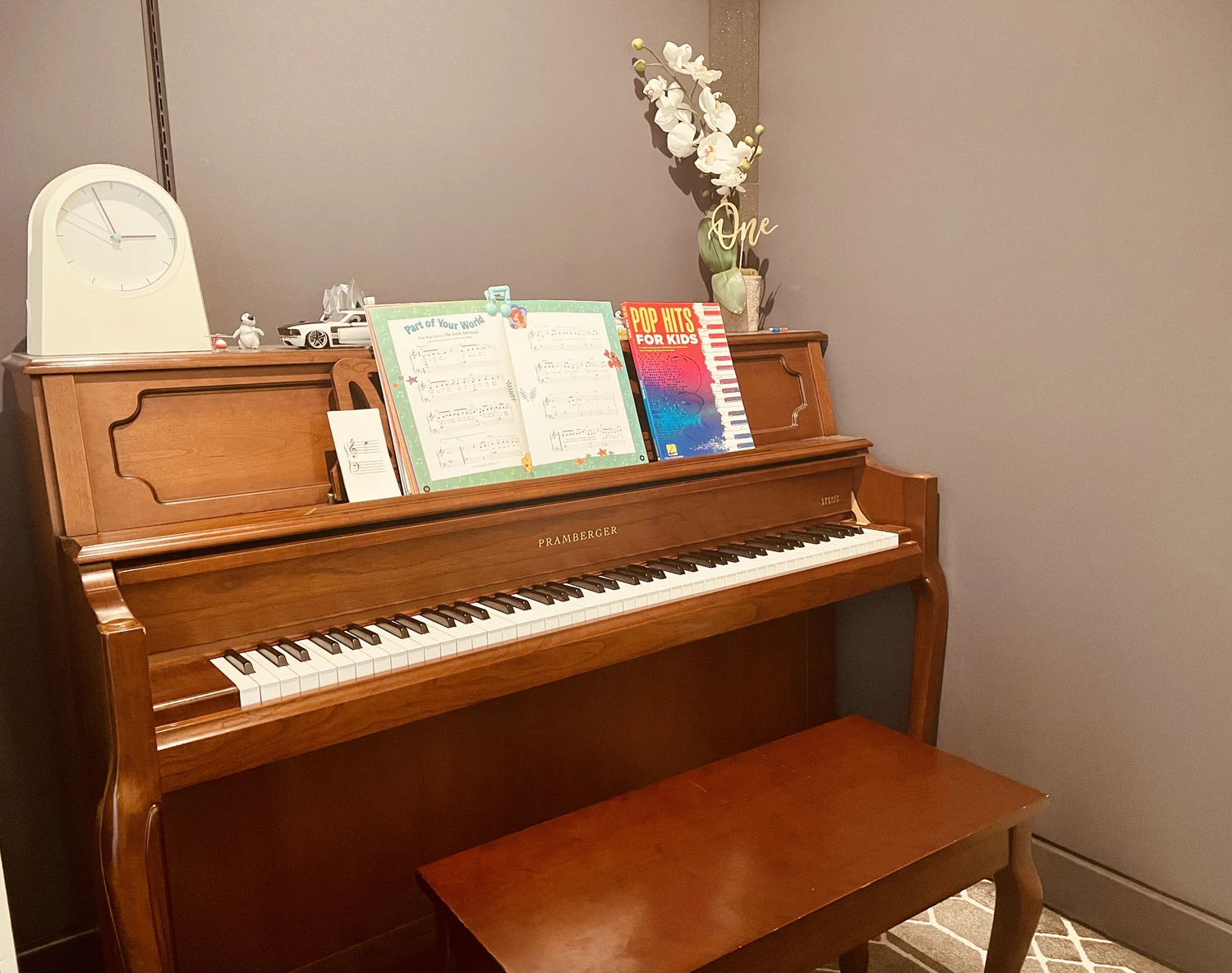An upright piano with music books.