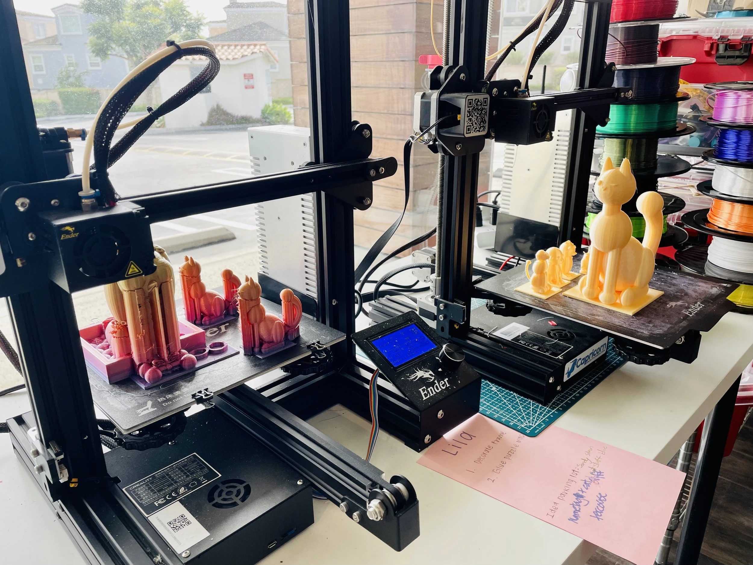 3D printers and a row of printed models.