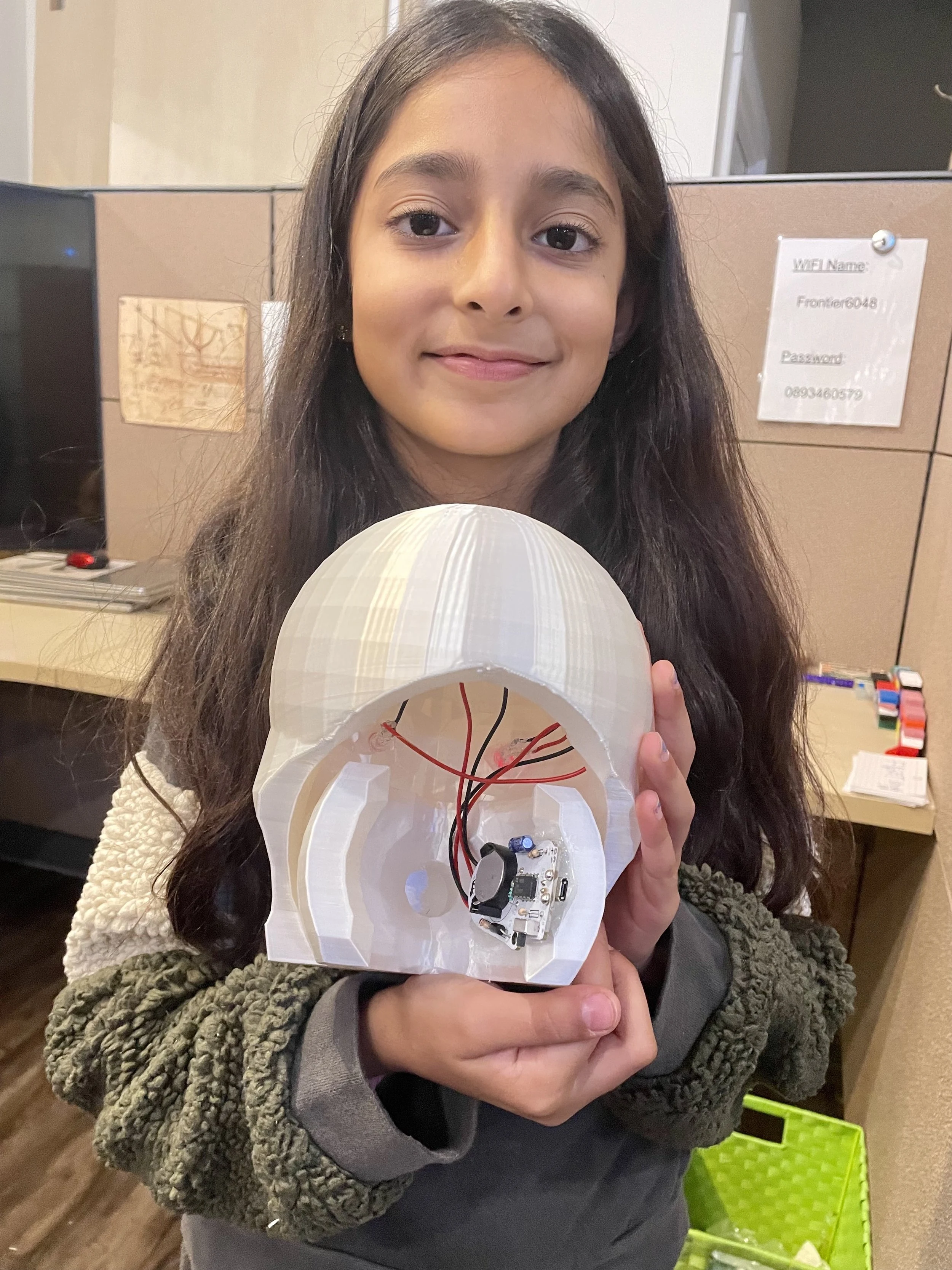 A student holding a constructed device.
