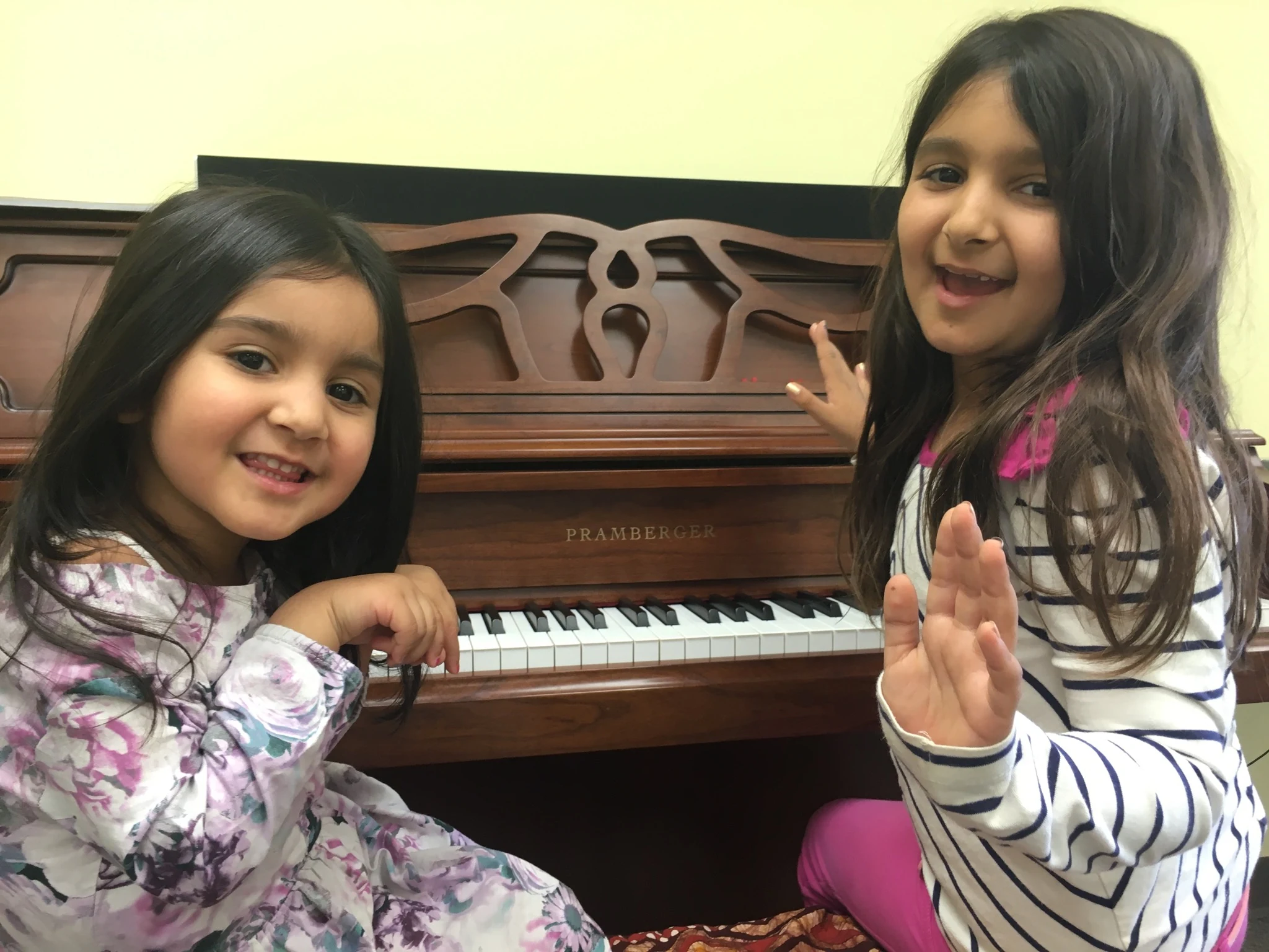Two students beside a piano.
