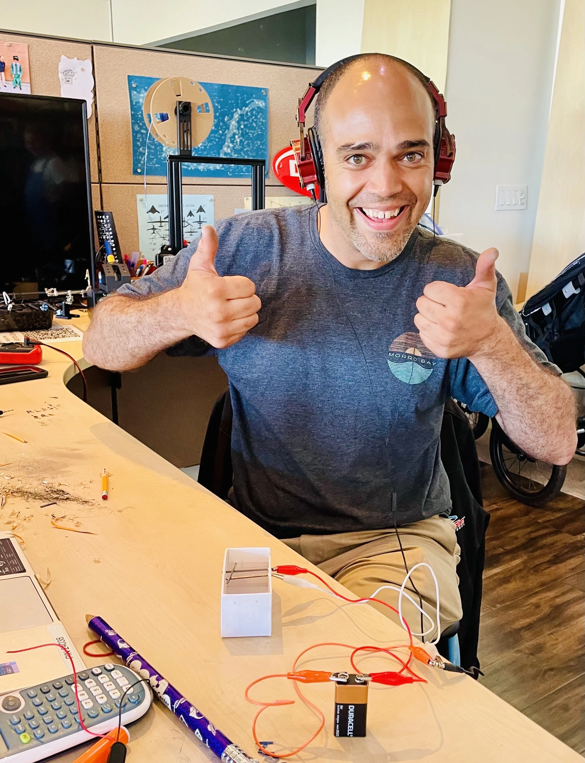 An educator at an electronics-project table.