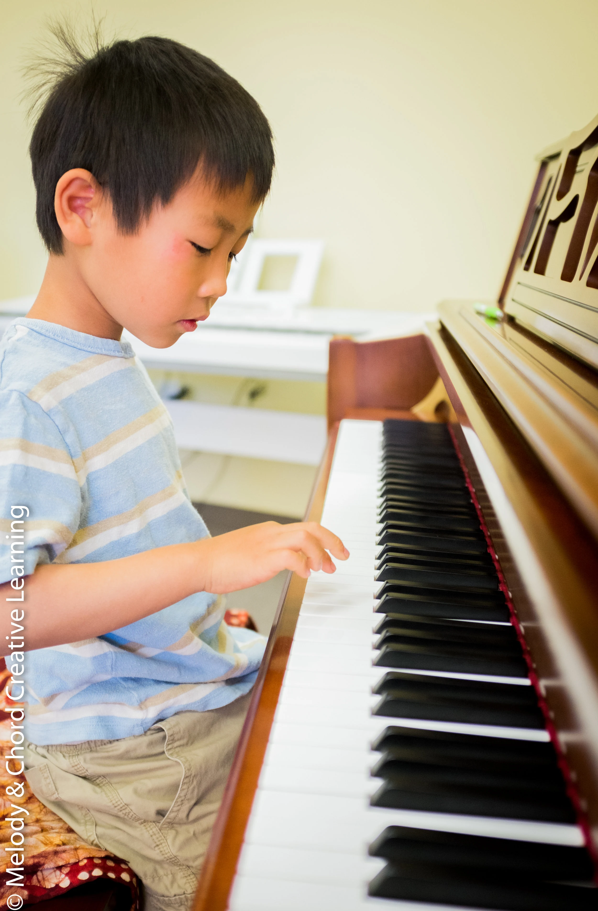 A student at an upright piano.