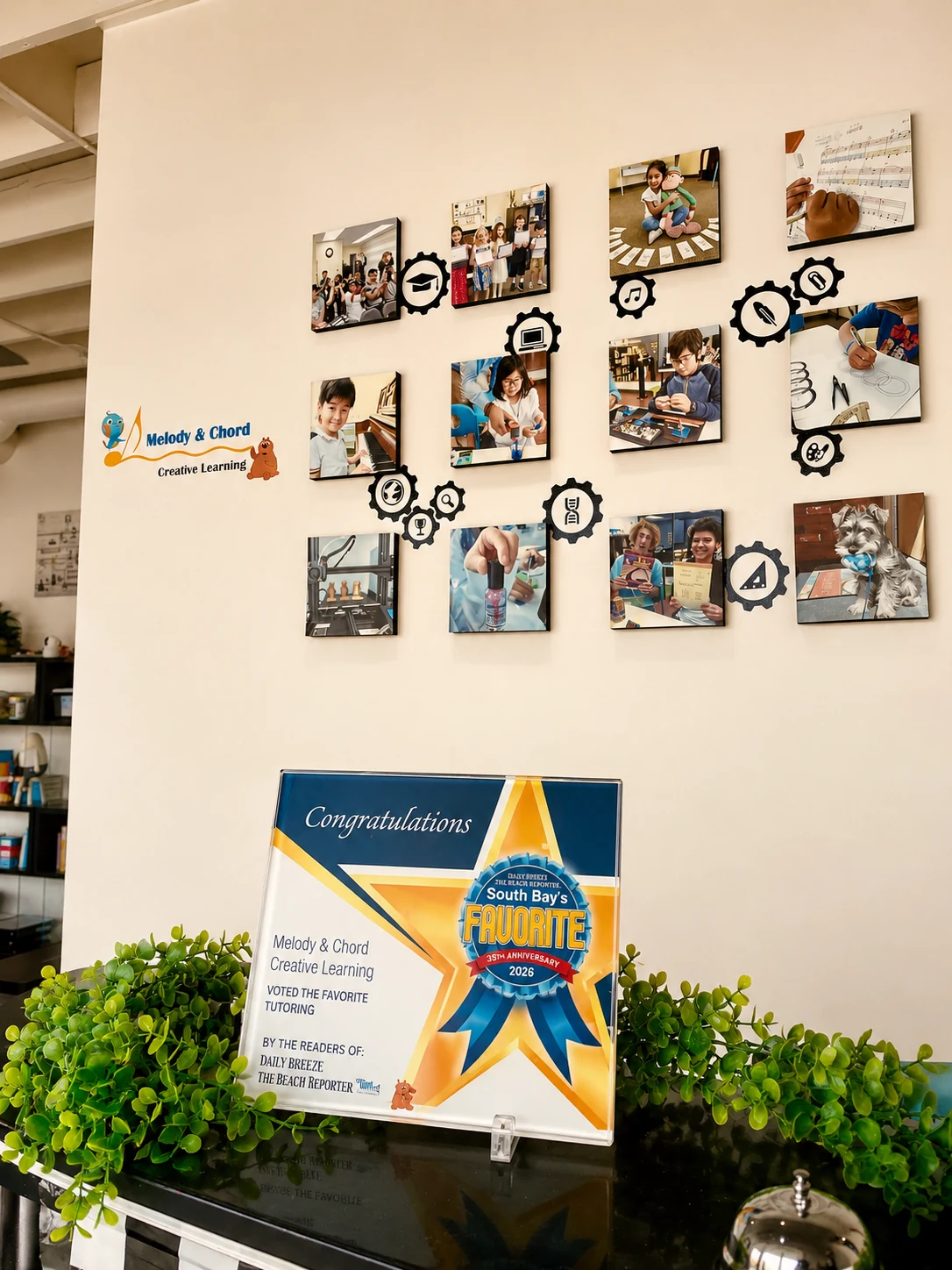 A display of photographs and a school recognition graphic.