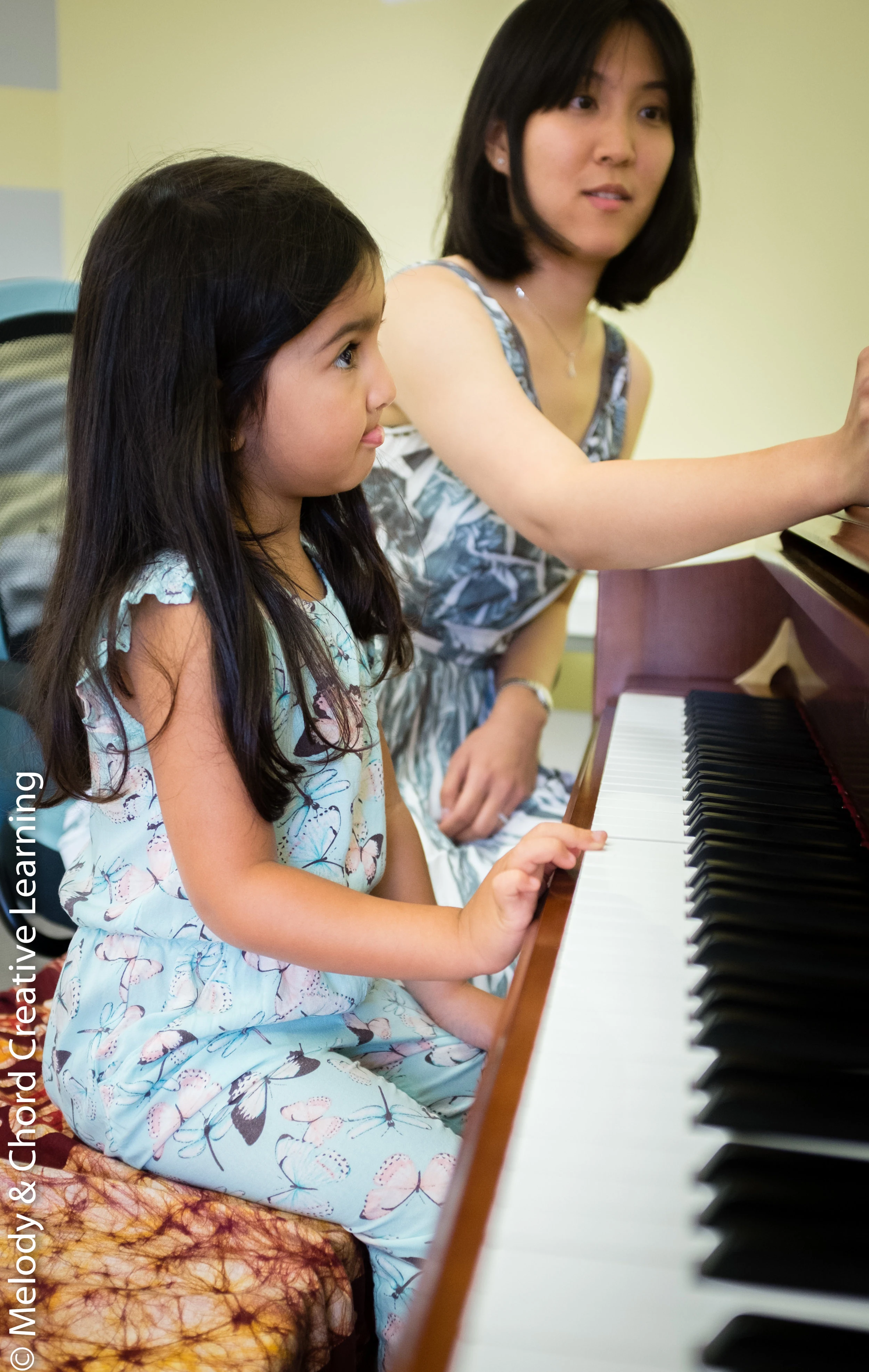 A student and educator at a piano.