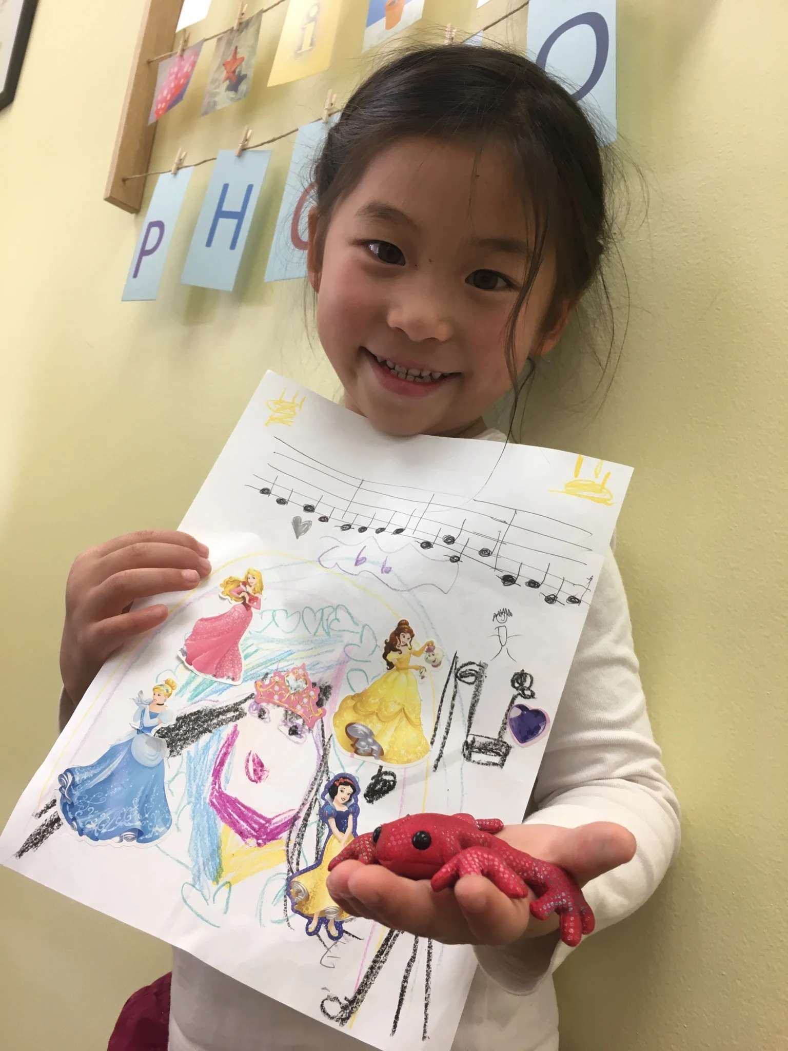 A student holding a piece of music artwork.
