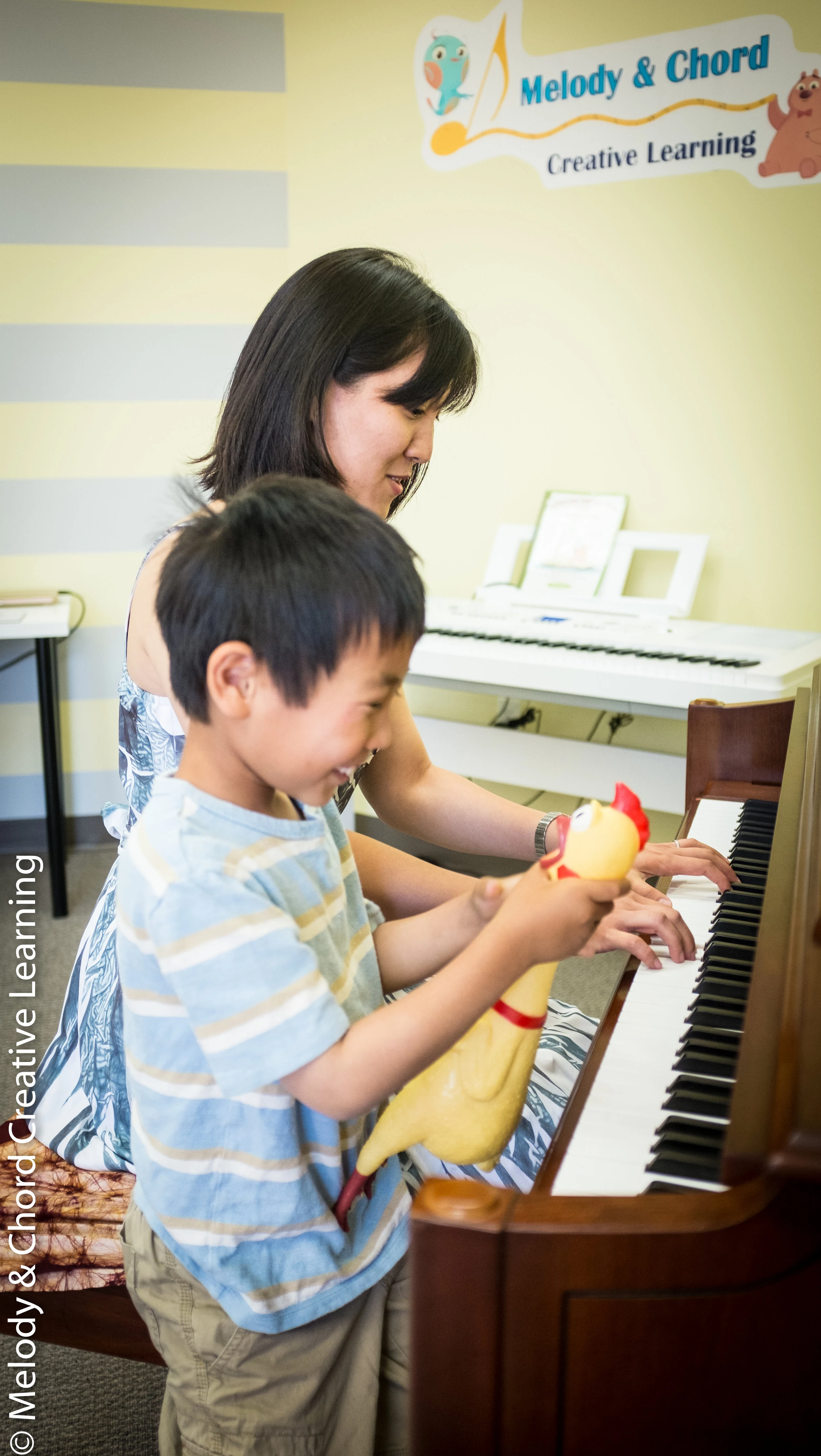 Piano coaching with a young student.