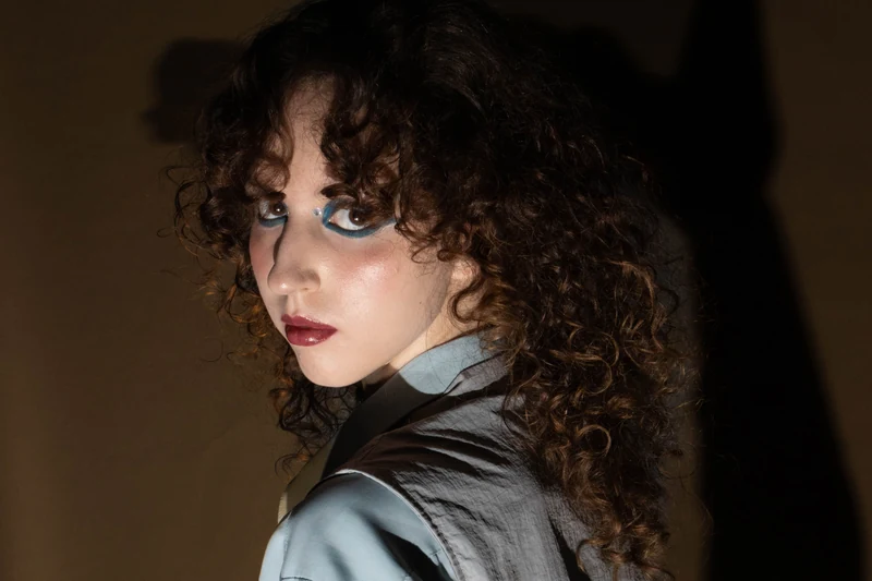 Fashion portrait with long, defined dark curls