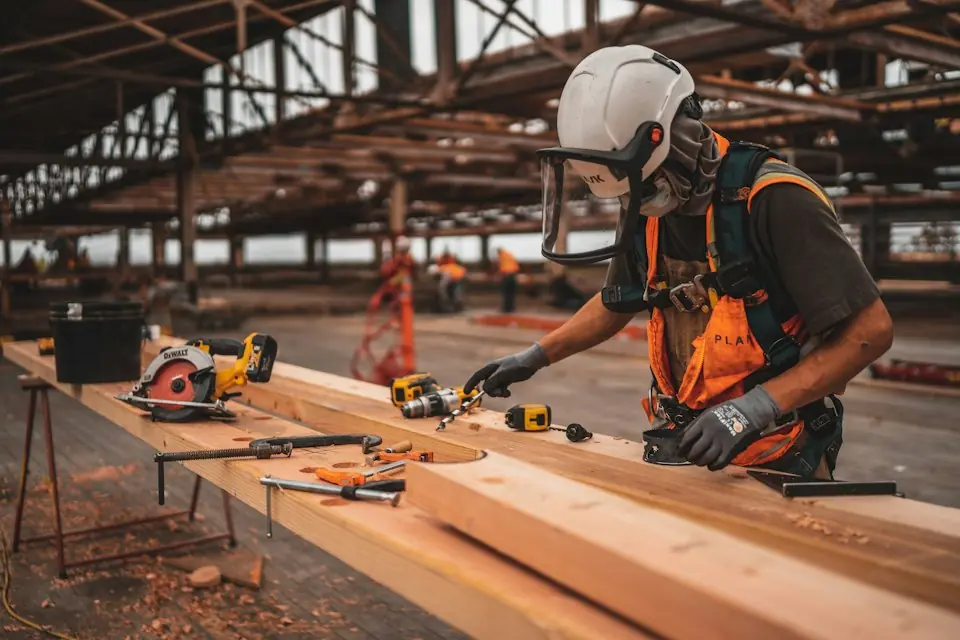 Brasstech, Inc. · Carpenter measuring timber on a workbench — illustrative stock photograph 2