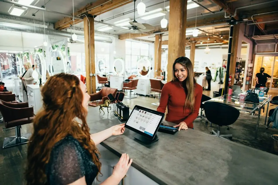 Moving · Retail worker assisting a customer at a counter — illustrative stock photograph