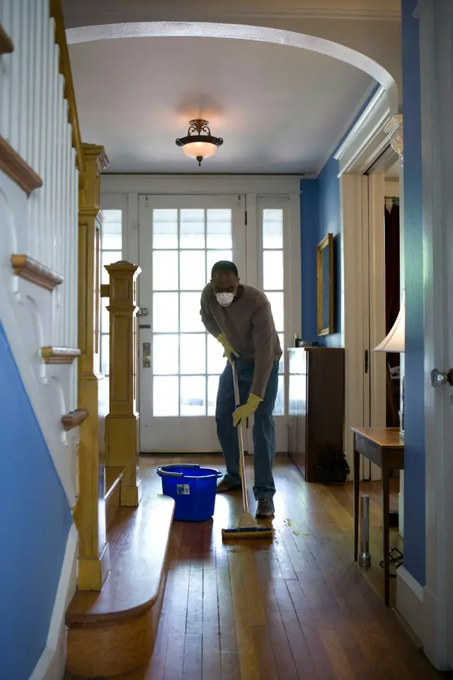 Boardwalk Cleaners · Person cleaning an interior doorway — illustrative stock photograph 7