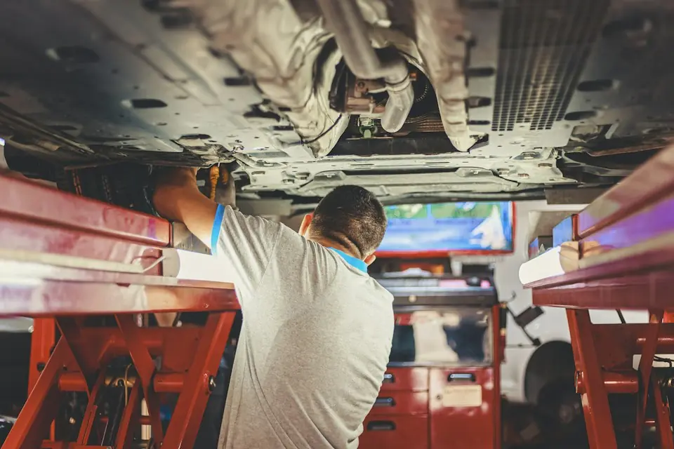 Albertos Polishing · Technician servicing a raised car in a workshop — illustrative stock photograph 6