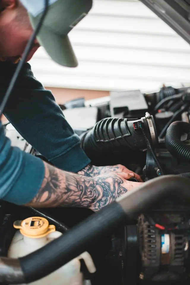 Albertos Polishing · Mechanic reaching into an engine bay — illustrative stock photograph 8