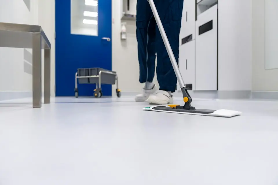 Cleaning · Cleaner mopping an indoor floor — illustrative stock photograph