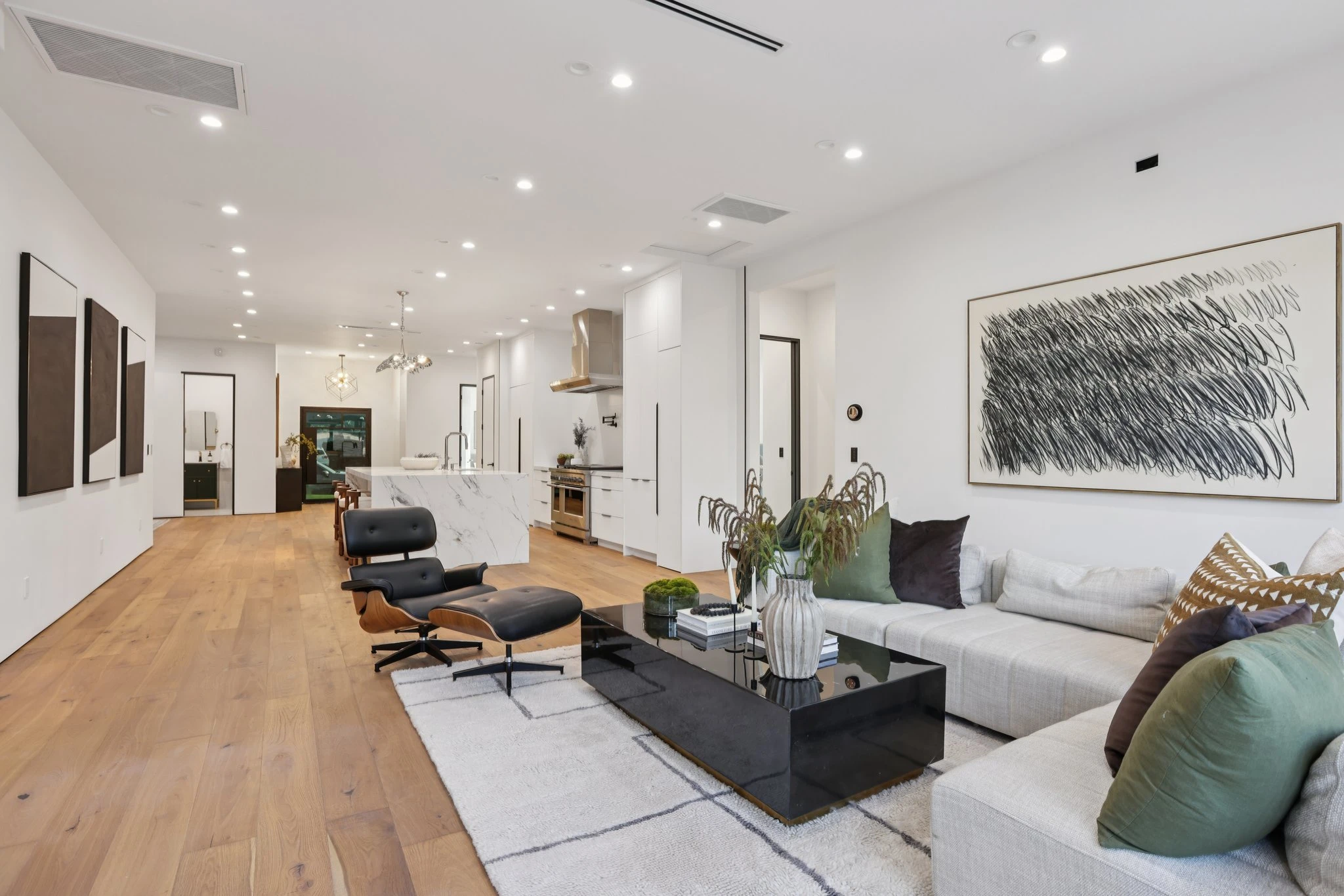 Riviosa Via del Valle living room with linear ceiling AC vents and a round wall thermostat