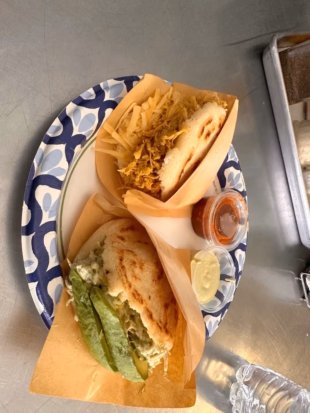 Venezuelan Bakery & Cafe · two filled arepas with sauces